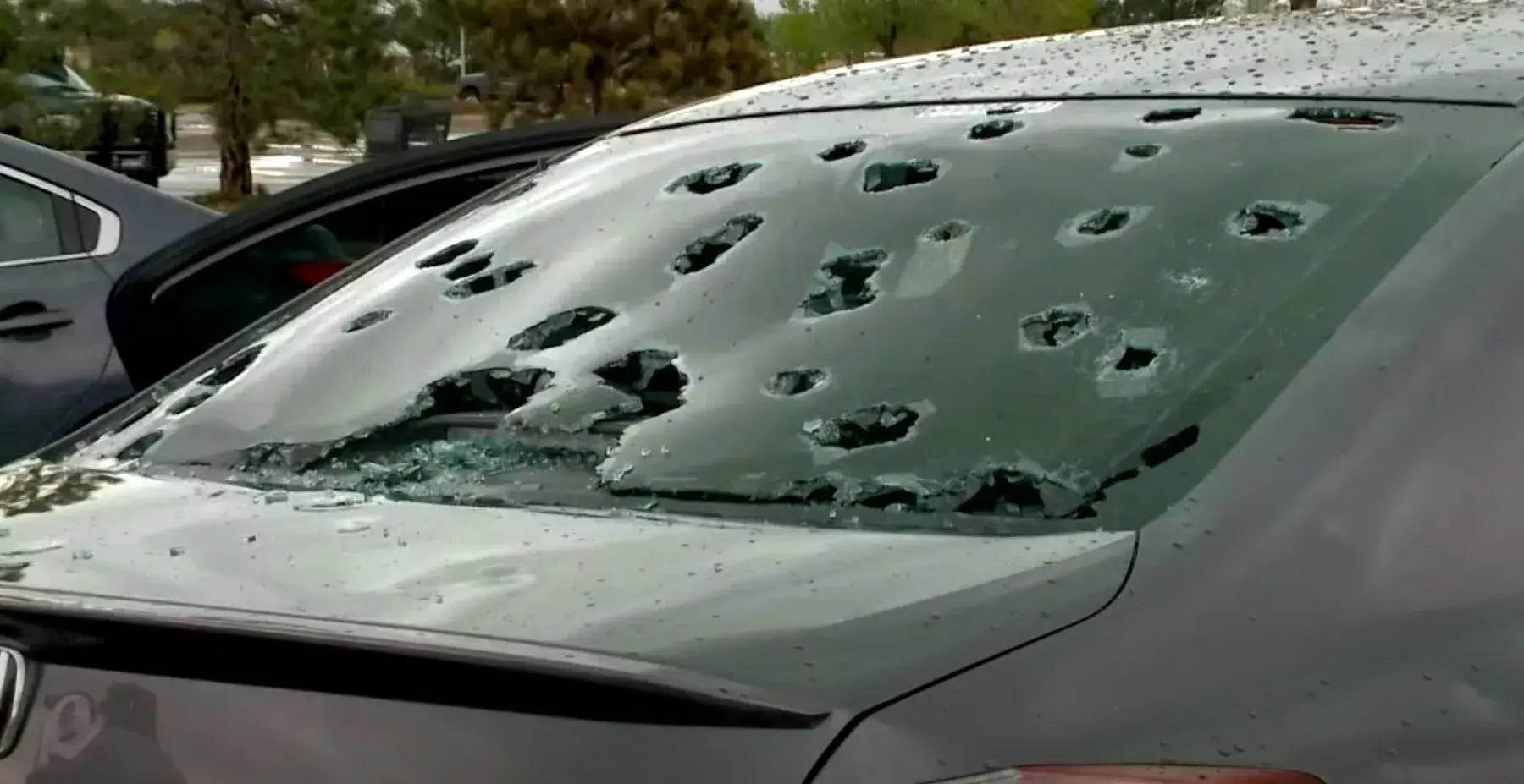 A commercial building under falling hail, illustrating a Colorado storm damage claim